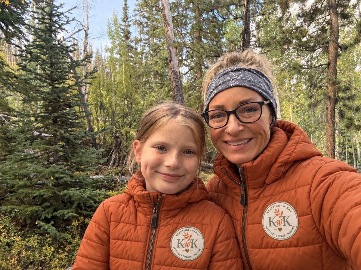 Kay and a young crafter in the woods, wearing matching KwK jackets